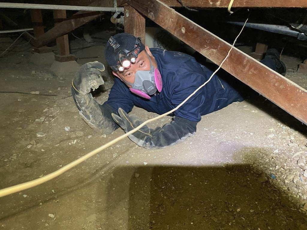 John inspecting a crawlspace